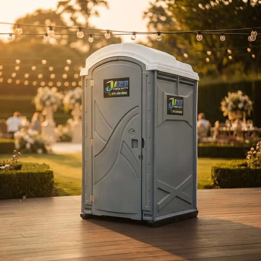 A restroom trailer at a backyard wedding reception at dusk.