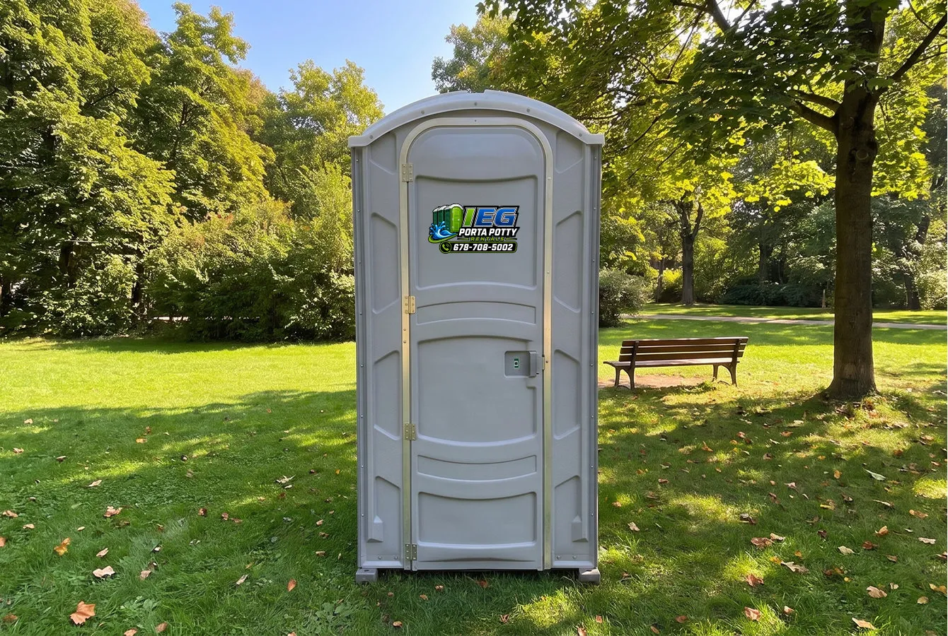 A standard blue porta potty on a construction site.